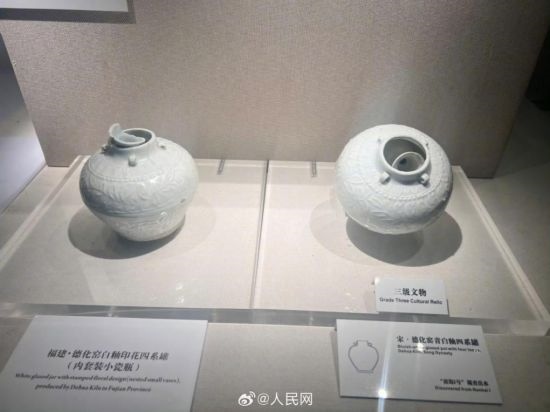 福建德化窯白釉印花四系罐（左）。人民網(wǎng)記者 李娜攝