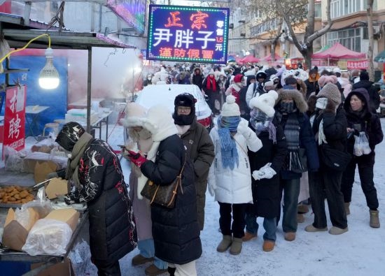 在哈爾濱紅專街早市，顧客們排起長隊購買油炸糕（1月22日攝）。新華社記者 王毓國 攝