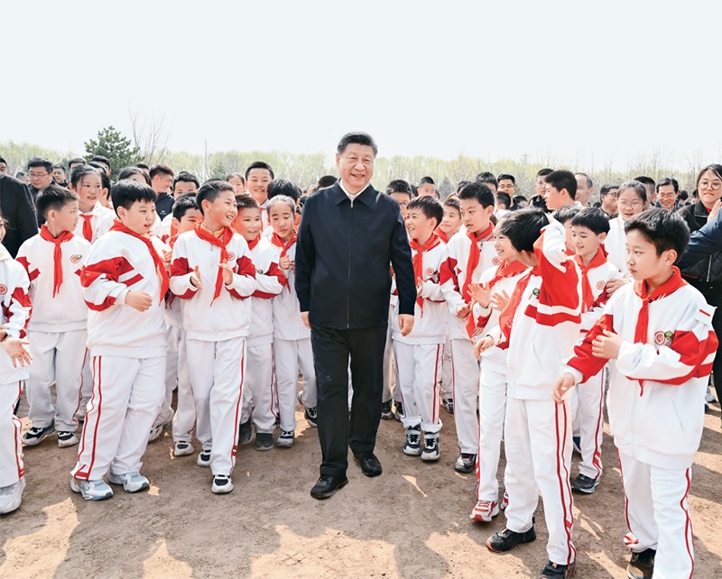 2024年4月3日，黨和國家領(lǐng)導(dǎo)人習(xí)近平、李強、趙樂際、王滬寧、蔡奇、丁薛祥、李希、韓正等來到北京市通州區(qū)潞城鎮(zhèn)參加首都義務(wù)植樹活動。這是習(xí)近平同少先隊員在一起。 新華社記者 李學(xué)仁/攝